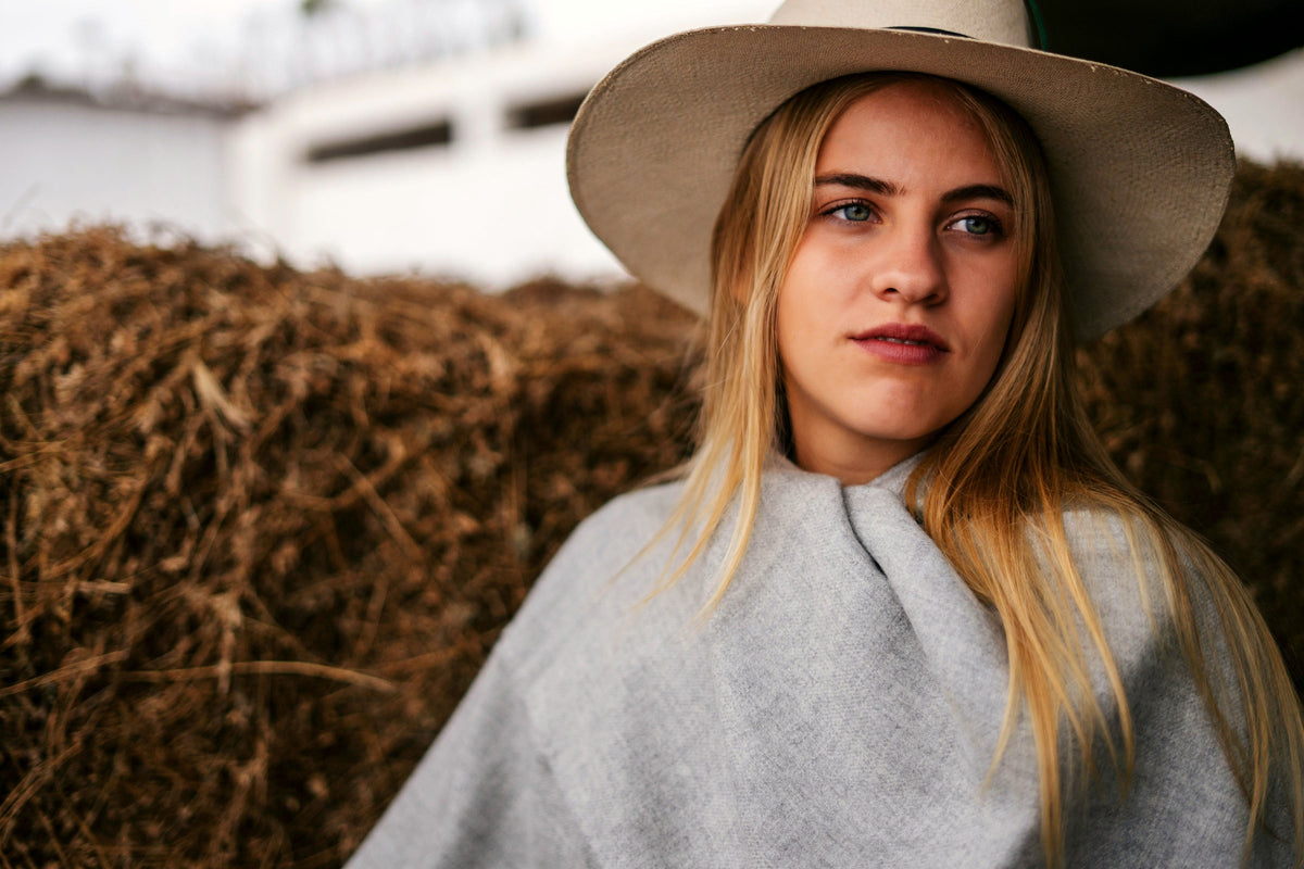 Storm grey alpaca throw over the shoulders, portrait in a hacienda yard